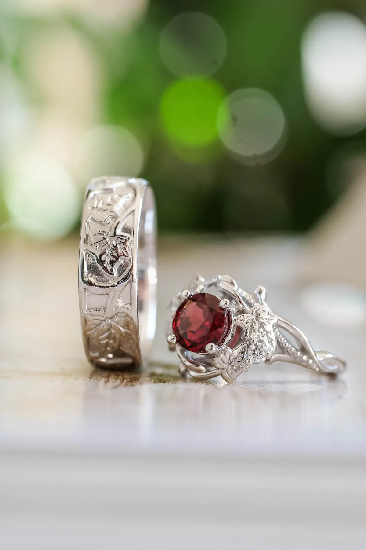 Wedding rings set for couples: gold ivy leaves band for him, gold ivy leaves ring with garnet for her