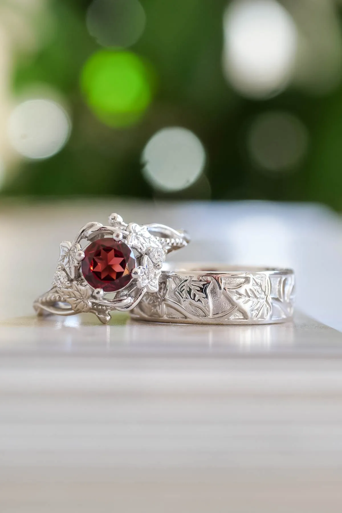 Wedding rings set for couples: gold ivy leaves band for him, gold ivy leaves ring with garnet for her