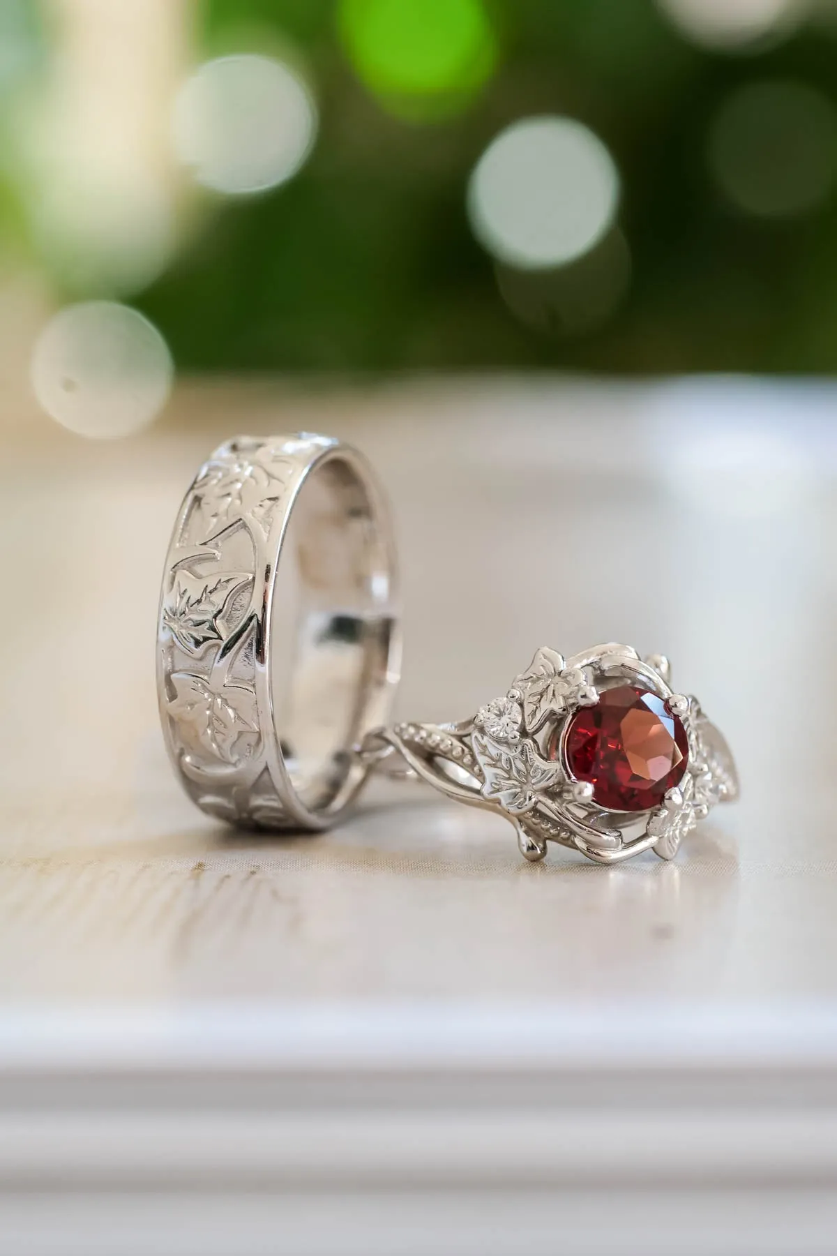 Wedding rings set for couples: gold ivy leaves band for him, gold ivy leaves ring with garnet for her